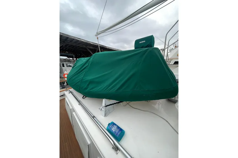 Amazing Grace Yacht Photos Pics 1983 Grand Banks 49 Classic yacht deck with green cover and cloudy sky.