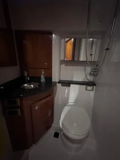 Zincohvid Yacht Photos Pics Compact bathroom in 2008 Four Winns V458 yacht with sink, toilet, and mirror.