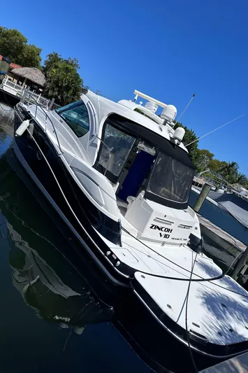 Zincohvid Yacht Photos Pics 2008 Four Winns V458 yacht docked in a marina under clear blue skies.