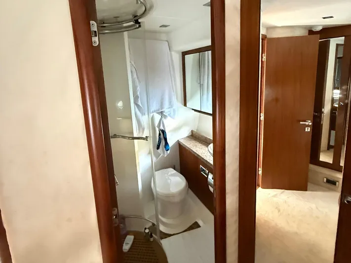  Yacht Photos Pics Bathroom interior of 2008 Sunseeker Manhattan 60 yacht, featuring shower and wooden cabinetry.