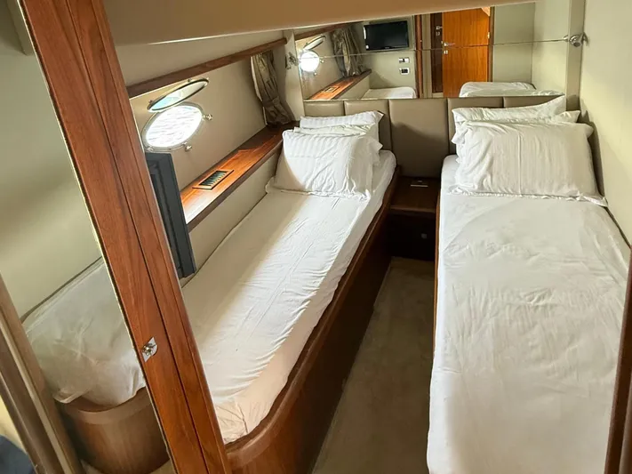  Yacht Photos Pics Twin cabin interior of 2008 Sunseeker Manhattan 60 yacht, featuring cozy beds and wooden accents.