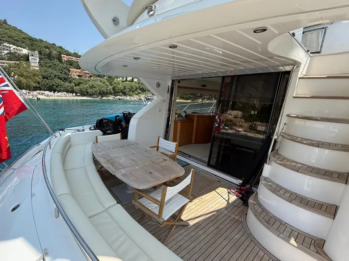  Yacht Photos Pics 2008 Sunseeker Manhattan 60 yacht with outdoor seating and scenic waterfront view.