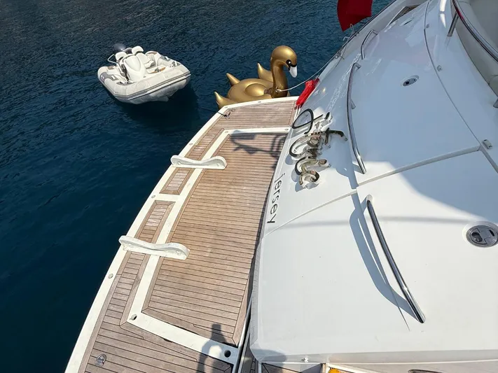  Yacht Photos Pics Sunseeker Manhattan 60 yacht with inflatable swan and dinghy on calm water, 2008 model.