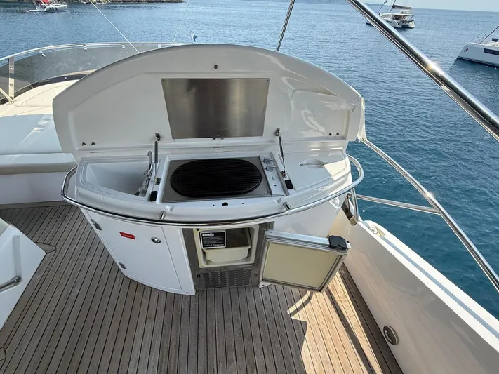  Yacht Photos Pics Outdoor grill on 2008 Sunseeker Manhattan 60 yacht deck, overlooking serene ocean waters.