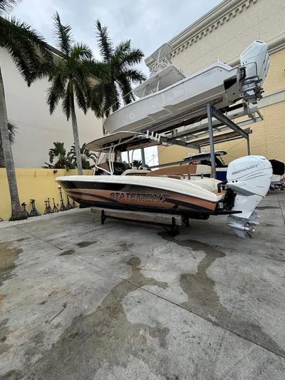  Yacht Photos Pics 2013 Statement 35 Center Console boat on a dock with palm trees in the background.