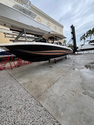  Yacht Photos Pics 2013 Statement 35 Center Console boat on dry dock, with overcast sky and palm trees.