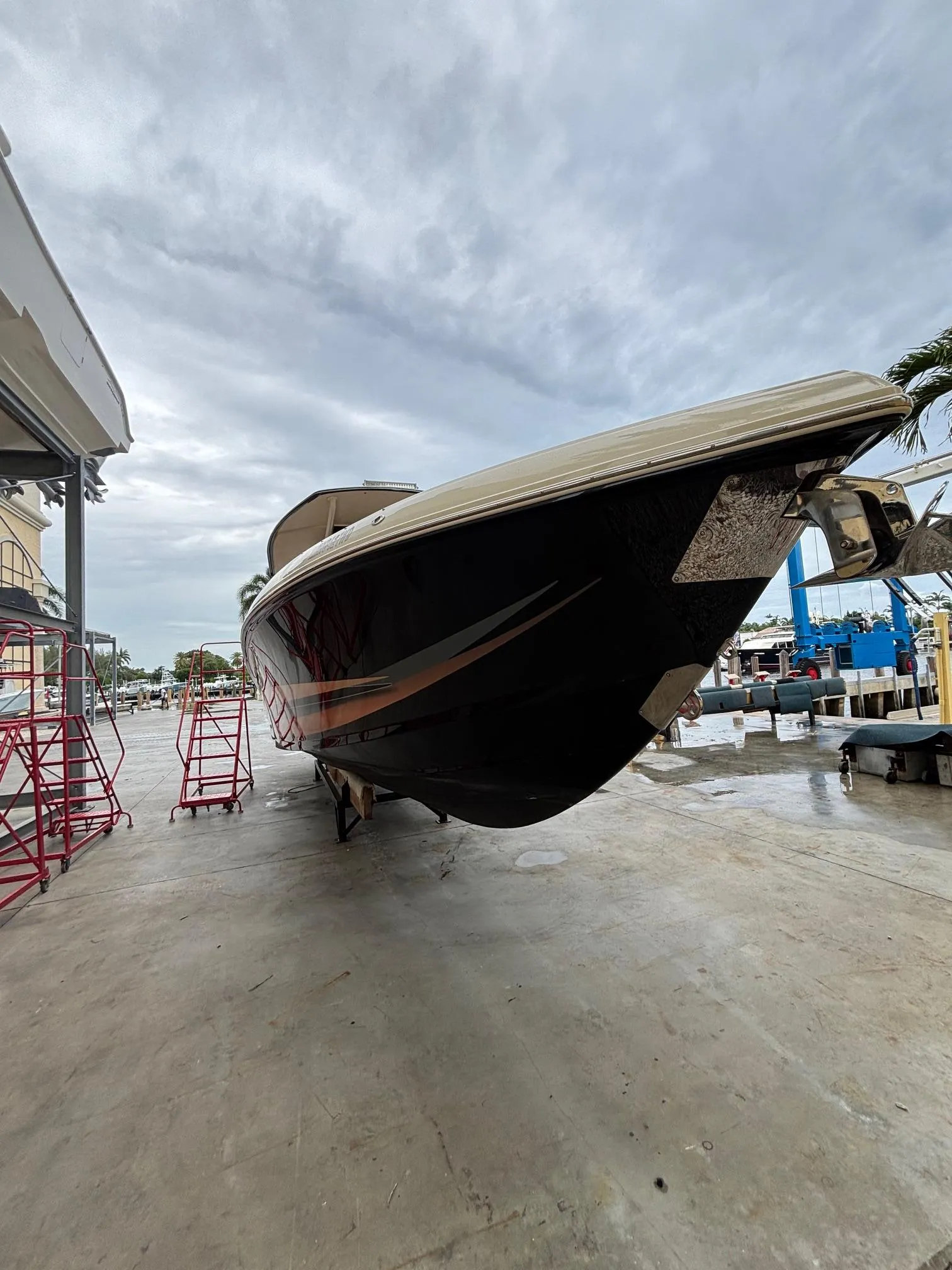 2013 Statement 35 Center Console boat on dry dock under cloudy sky.