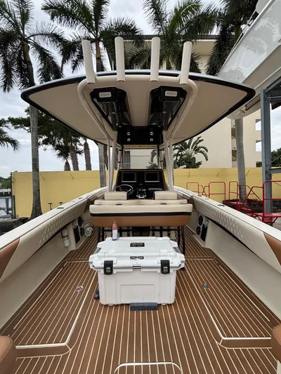  Yacht Photos Pics 2013 Statement 35 Center Console boat with teak flooring and palm trees in the background.