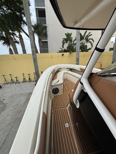  Yacht Photos Pics 2013 Statement 35 Center Console boat with sleek interior and wood accents, docked near palm trees.