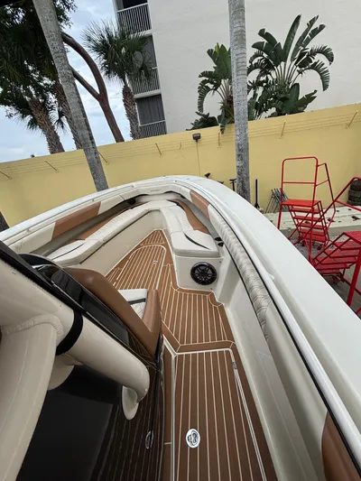  Yacht Photos Pics 2013 Statement 35 Center Console boat with sleek deck and seating, surrounded by tropical plants.