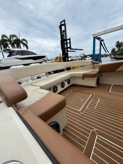  Yacht Photos Pics 2013 Statement 35 Center Console boat interior with brown and beige seating, docked near palm trees.