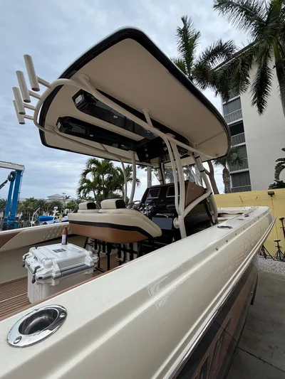  Yacht Photos Pics 2013 Statement 35 Center Console boat with T-top, docked near palm trees.