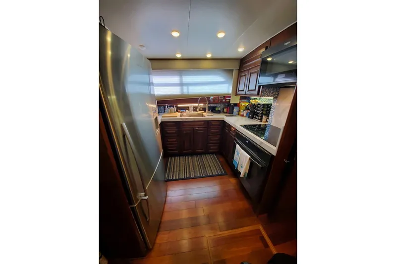  Yacht Photos Pics Luxurious kitchen interior of 1984 Hatteras 61 Cockpit MY yacht with modern appliances.