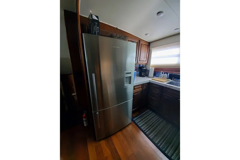  Yacht Photos Pics Kitchen interior of 1984 Hatteras 61 Cockpit MY with stainless steel refrigerator.