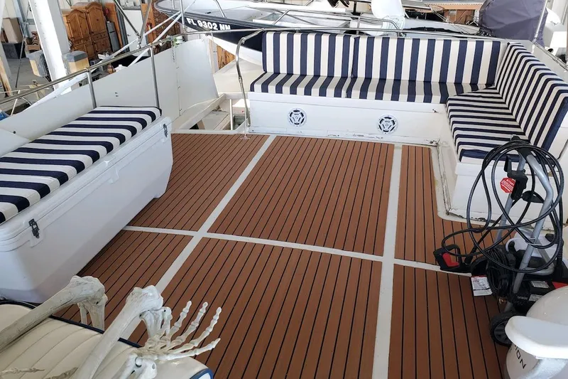  Yacht Photos Pics 1984 Hatteras 61 Cockpit MY with striped seating and teak deck flooring.