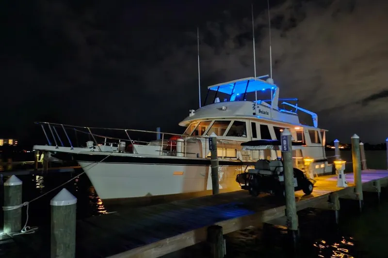  Yacht Photos Pics 1984 Hatteras 61 Cockpit MY yacht docked at night with blue lighting.