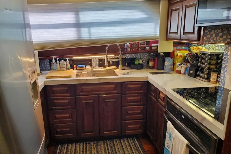  Yacht Photos Pics 1984 Hatteras 61 Cockpit MY yacht kitchen with modern appliances and wooden cabinetry.