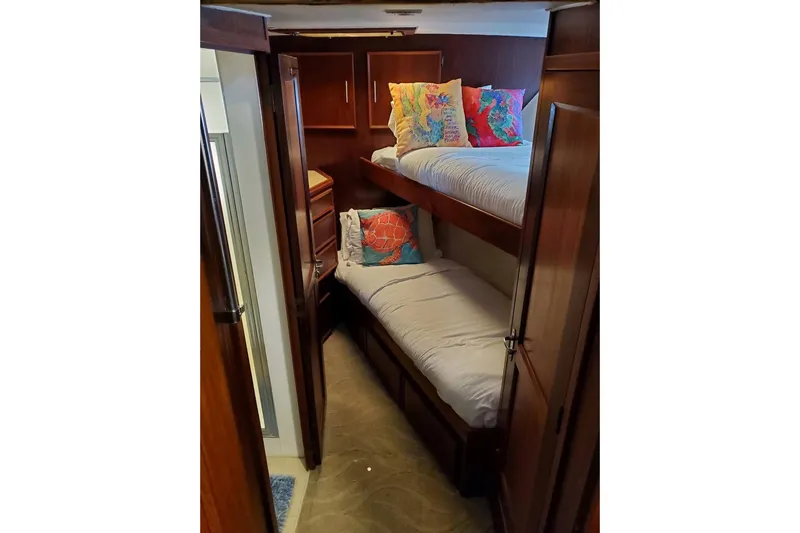  Yacht Photos Pics 1984 Hatteras 61 Cockpit MY cabin with bunk beds and colorful pillows.