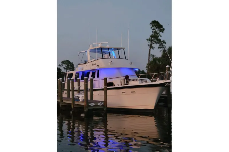  Yacht Photos Pics 1984 Hatteras 61 Cockpit MY yacht docked with blue lights at dusk.