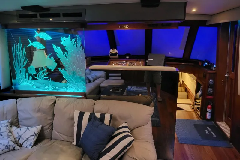  Yacht Photos Pics Luxurious interior of 1984 Hatteras 61 Cockpit MY yacht with aquarium and plush seating.