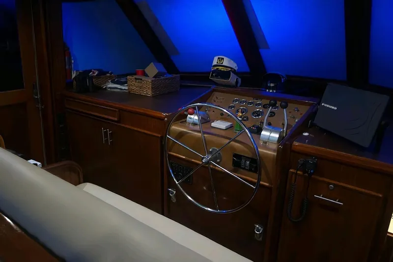  Yacht Photos Pics 1984 Hatteras 61 Cockpit MY helm with steering wheel, controls, and navigation equipment.