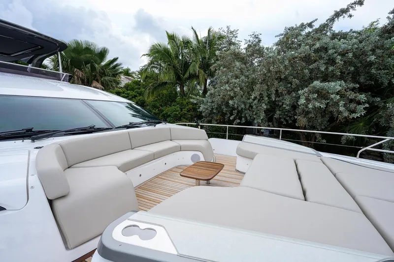 Escape Yacht Photos Pics Luxurious 2022 Princess Y85 Motor Yacht deck with plush seating and tropical backdrop.