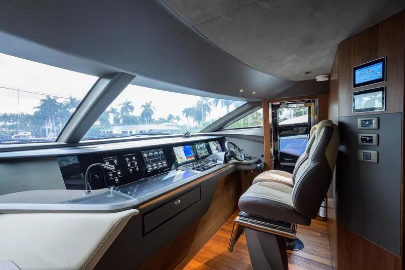 Escape Yacht Photos Pics Luxurious 2022 Princess Y85 Motor Yacht helm with modern controls and panoramic windows.