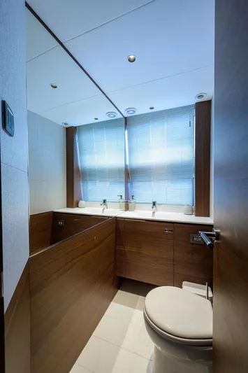 Escape Yacht Photos Pics Luxurious bathroom on 2022 Princess Y85 Motor Yacht with modern fixtures and wooden cabinetry.