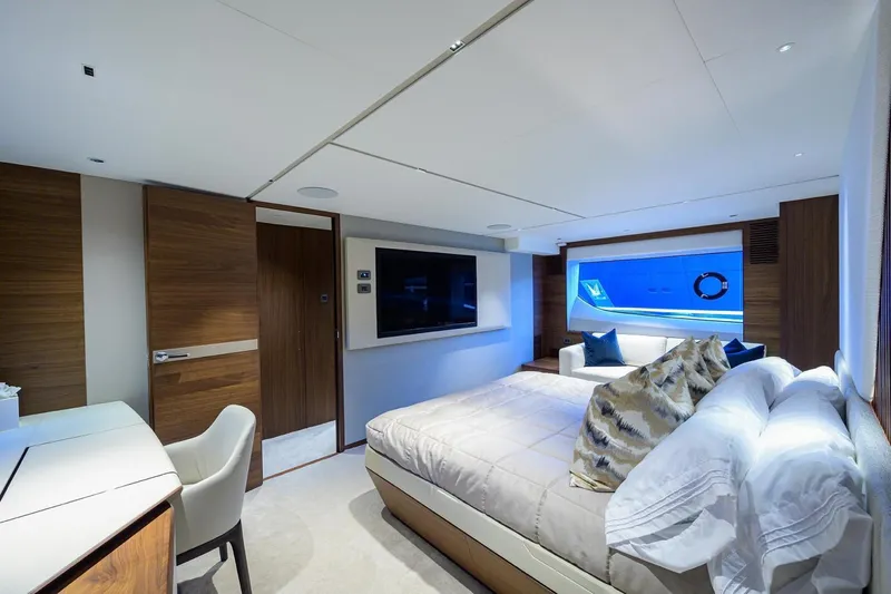 Escape Yacht Photos Pics Luxurious bedroom interior of 2022 Princess Y85 Motor Yacht with modern decor and large window.