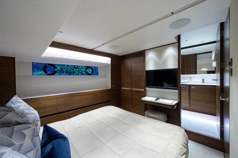 Escape Yacht Photos Pics Luxurious bedroom in 2022 Princess Y85 Motor Yacht with modern decor and TV.