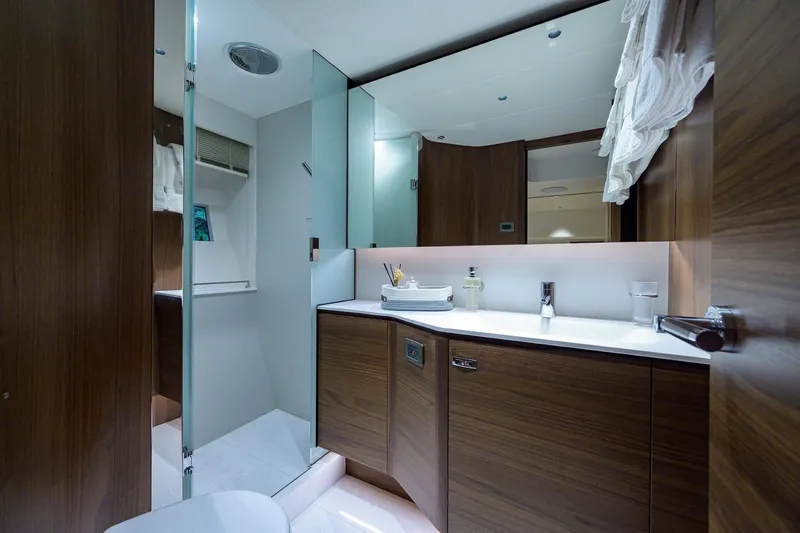 Escape Yacht Photos Pics Luxurious bathroom on 2022 Princess Y85 Motor Yacht with modern wood cabinetry.