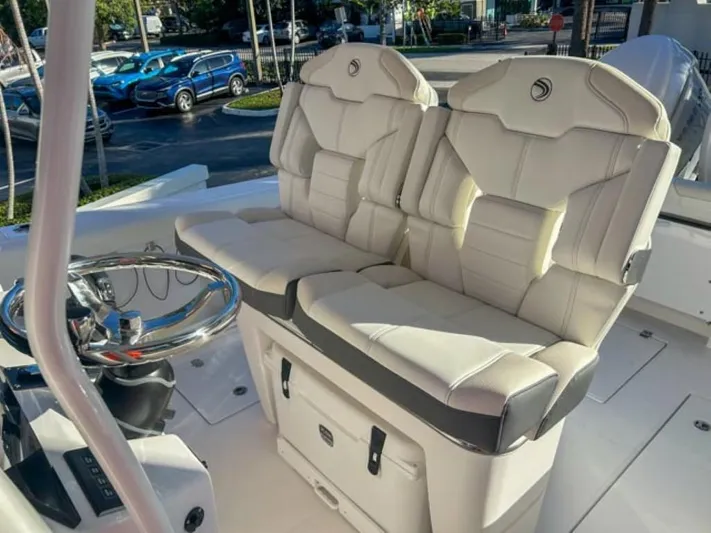  Yacht Photos Pics 2025 Edgewater 262CC boat interior with plush seating and modern steering console.