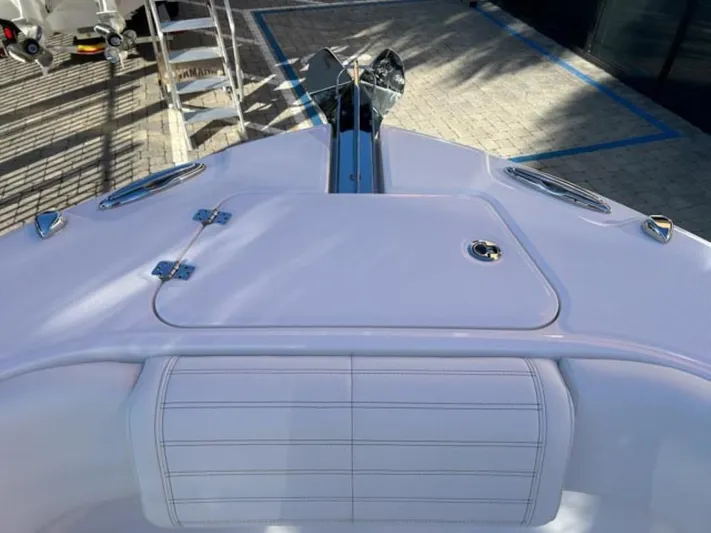  Yacht Photos Pics 2025 Edgewater 262CC boat deck with sleek design and storage compartment.