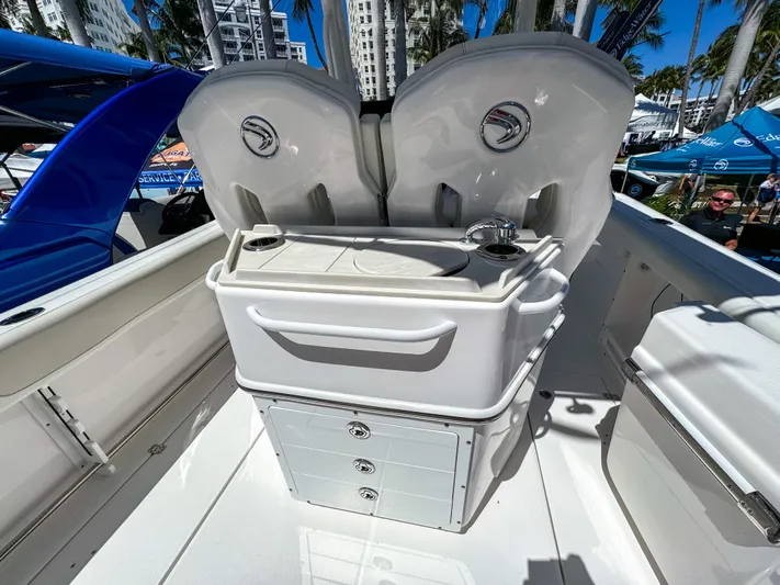  Yacht Photos Pics 2025 Edgewater 262CC boat interior with storage and seating, showcased outdoors.