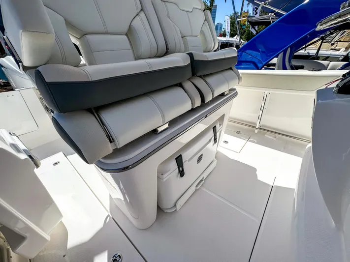  Yacht Photos Pics 2025 Edgewater 262CC boat interior with cushioned seating and storage compartment.