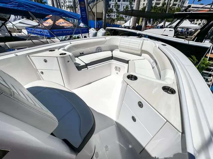  Yacht Photos Pics 2025 Edgewater 262CC boat interior with white seating and storage compartments.