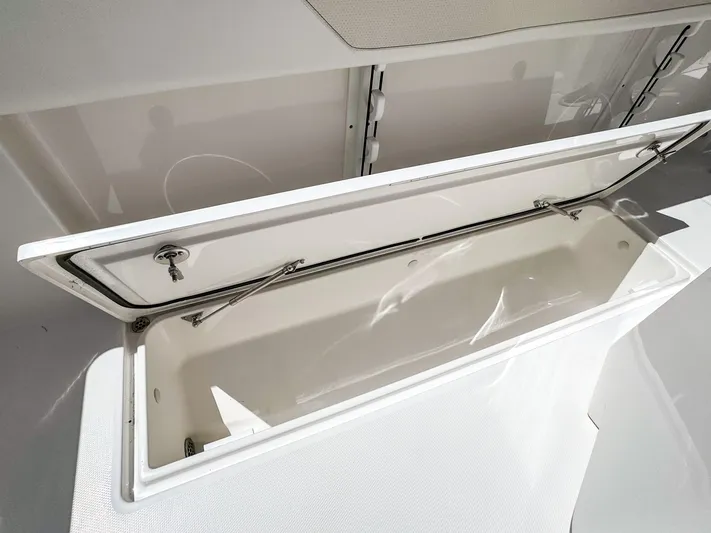  Yacht Photos Pics Open storage compartment on 2025 Edgewater 262CC boat, showcasing spacious interior design.