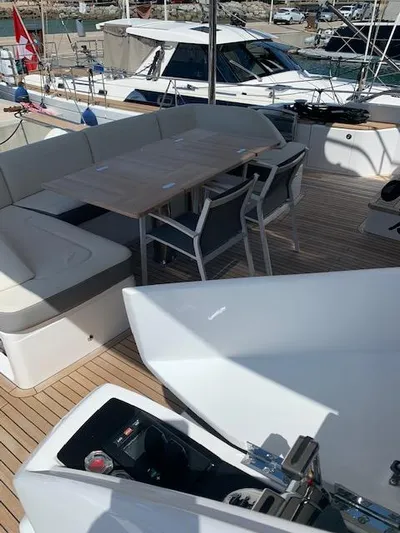  Yacht Photos Pics Luxury yacht deck with seating and table, Princess 75, 2018 model, docked at marina.