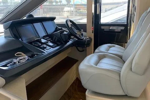  Yacht Photos Pics Interior cockpit of 2018 Princess 75 yacht with modern controls and plush seating.