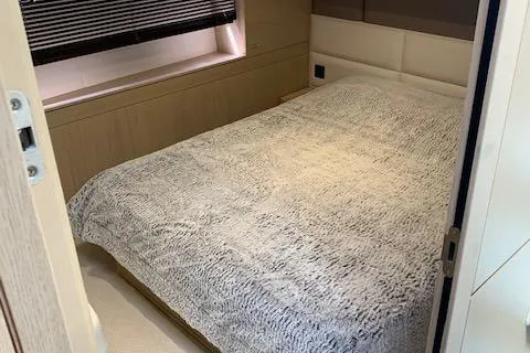  Yacht Photos Pics Luxurious bedroom interior of 2018 Princess 75 yacht with plush bedding.