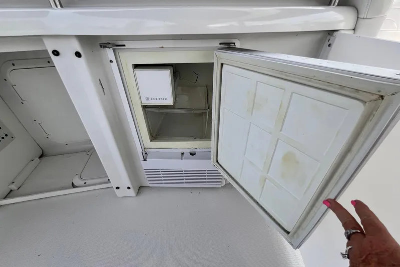 La Bella Vita Yacht Photos Pics Open mini fridge on 2003 Formula 400 Super Sport boat, showing interior storage space.