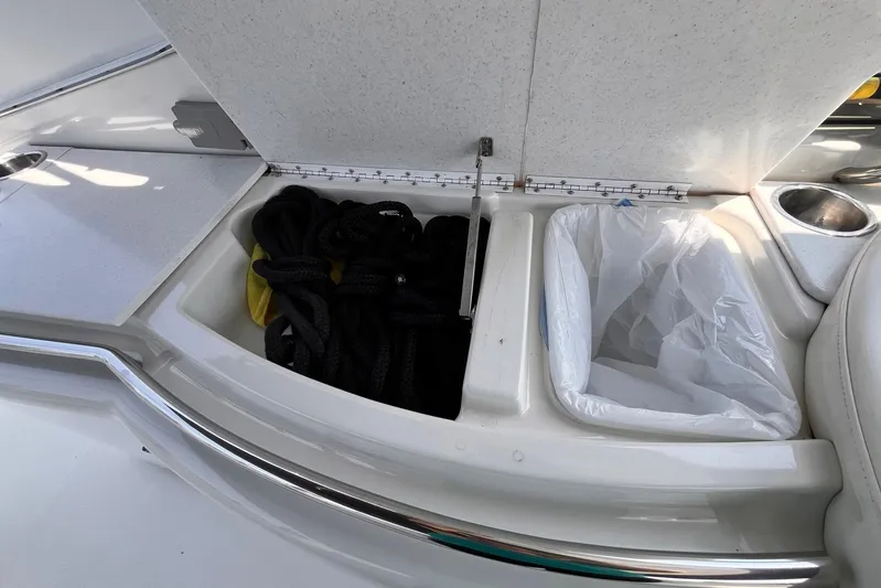 La Bella Vita Yacht Photos Pics 2003 Formula 400 Super Sport boat storage compartment with rope and trash bin.