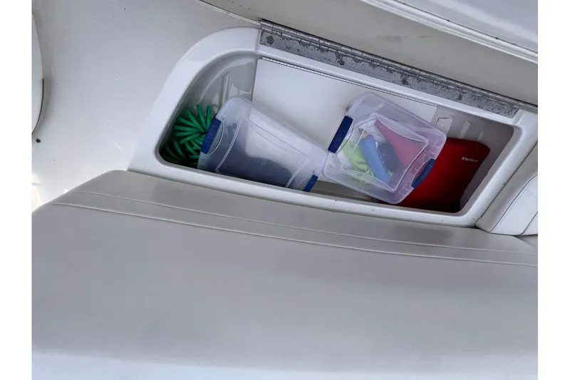 La Bella Vita Yacht Photos Pics Storage compartment on a 2003 Formula 400 Super Sport boat with containers and cleaning supplies.