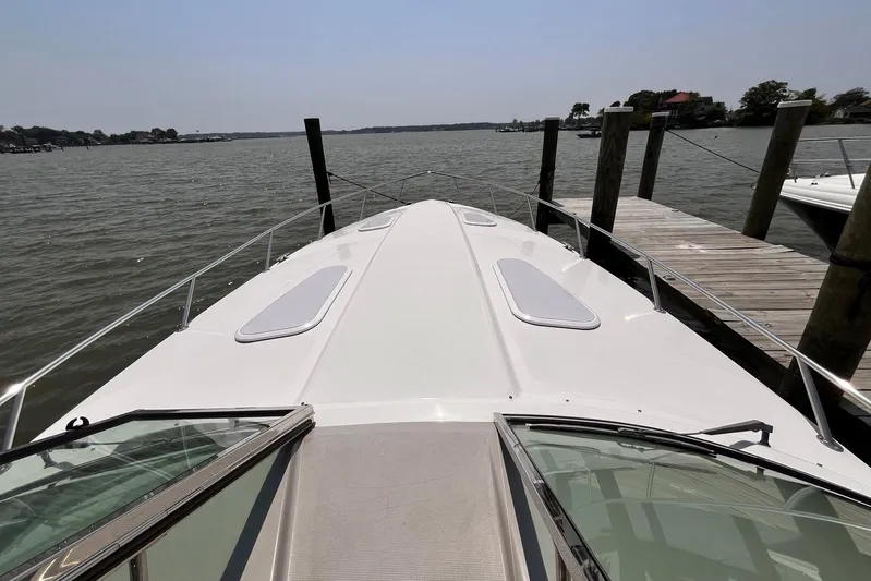 La Bella Vita Yacht Photos Pics 2003 Formula 400 Super Sport boat docked by a wooden pier on a sunny day.
