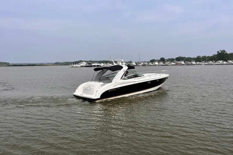 La Bella Vita Yacht Photos Pics 2003 Formula 400 Super Sport boat cruising on a calm lake.