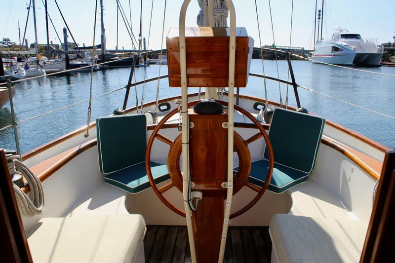 La Vie En Rose Yacht Photos Pics Cockpit of 2012 Custom Gartside Jespersen 40 sailboat with wooden wheel and seating.