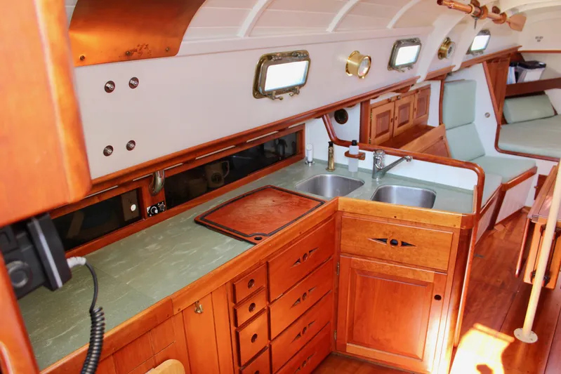 La Vie En Rose Yacht Photos Pics Interior of 2012 Custom Gartside Jespersen 40 yacht with wooden cabinetry and dual sinks.