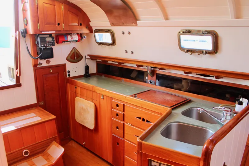 La Vie En Rose Yacht Photos Pics Custom Gartside Jespersen 40 yacht interior, 2012 model, featuring a wooden kitchen with dual sinks.