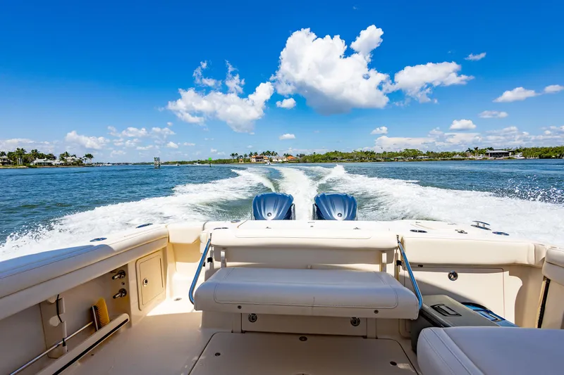  Yacht Photos Pics 2018 Grady-White Freedom 335 cruising on a sunny day with a scenic water view.