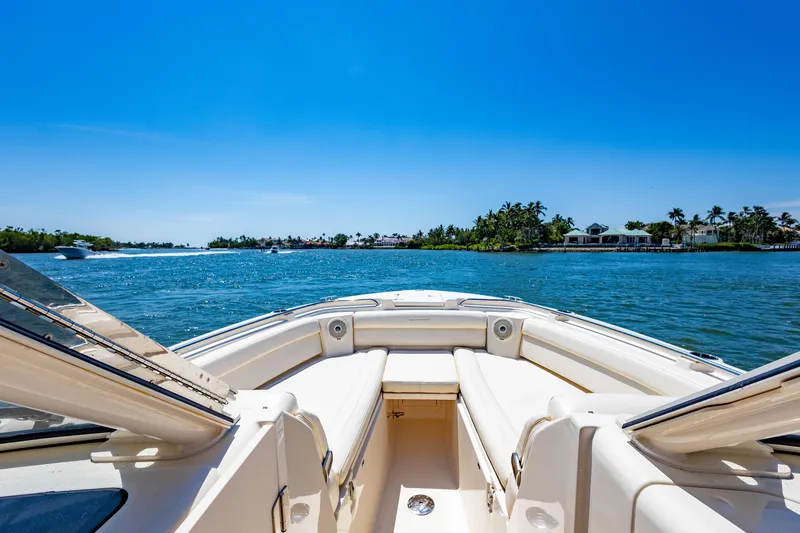  Yacht Photos Pics 2018 Grady-White Freedom 335 boat on a sunny day, cruising near a tropical shoreline.